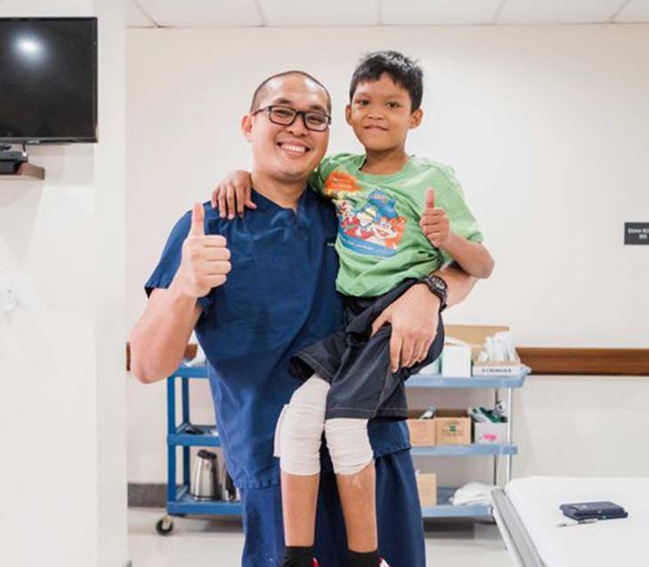 Dr and kid with bandages on his legs